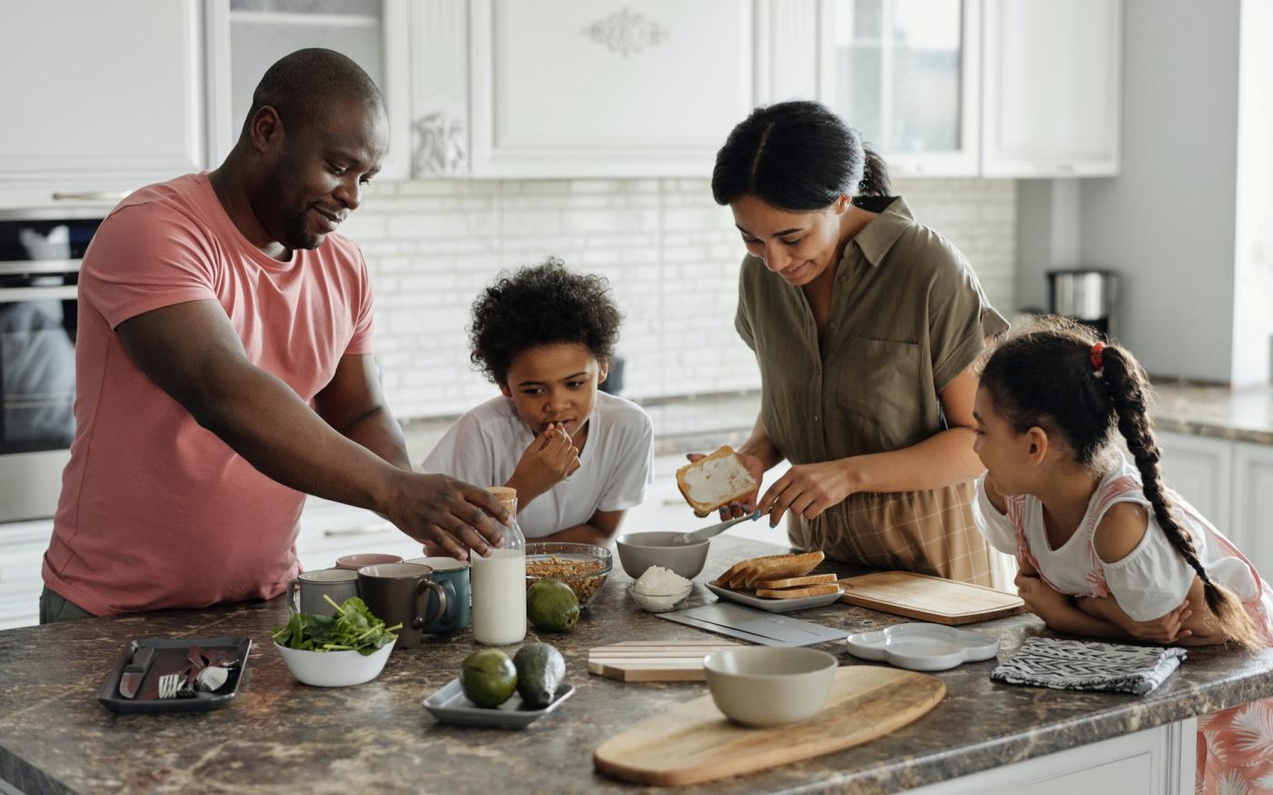 Family with two children making breakfast